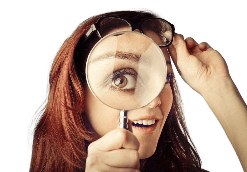 Woman looking through magnifying glass